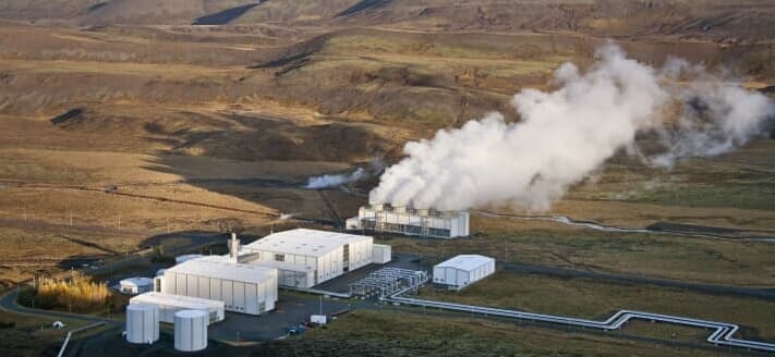 Clean energy plant releasing steam across open terrain